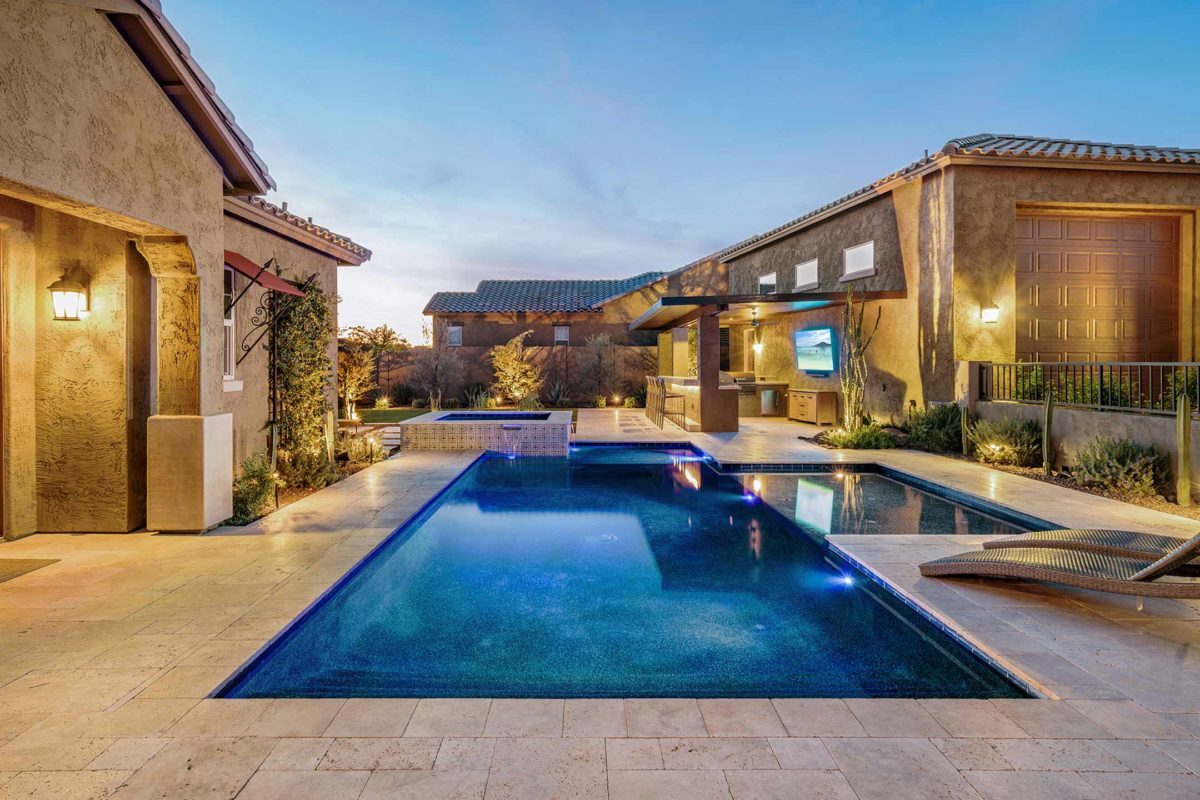 photo of a backyard pool design in PebbleTec PebbleBrilliance Tropicana Pool Finish dark blue water color