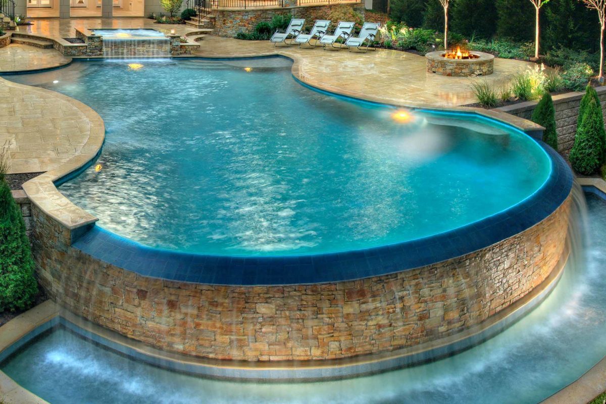 photo of a backyard pool design in PebbleTec Tahoe Blue Pool Finish medium blue water color by Lewis Aguatech