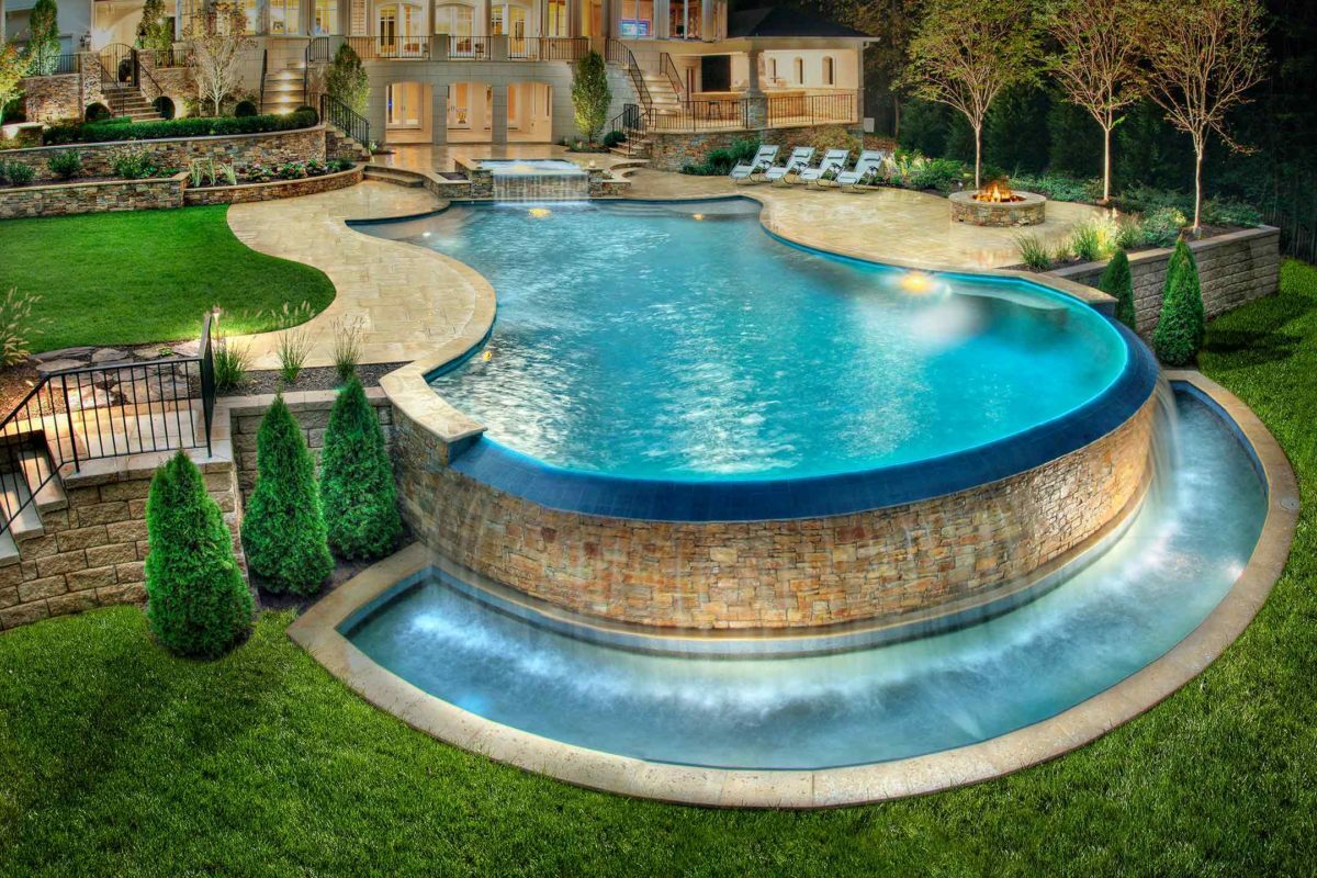 photo of a backyard pool design in PebbleTec Tahoe Blue Pool Finish medium blue water color by Lewis Aguatech