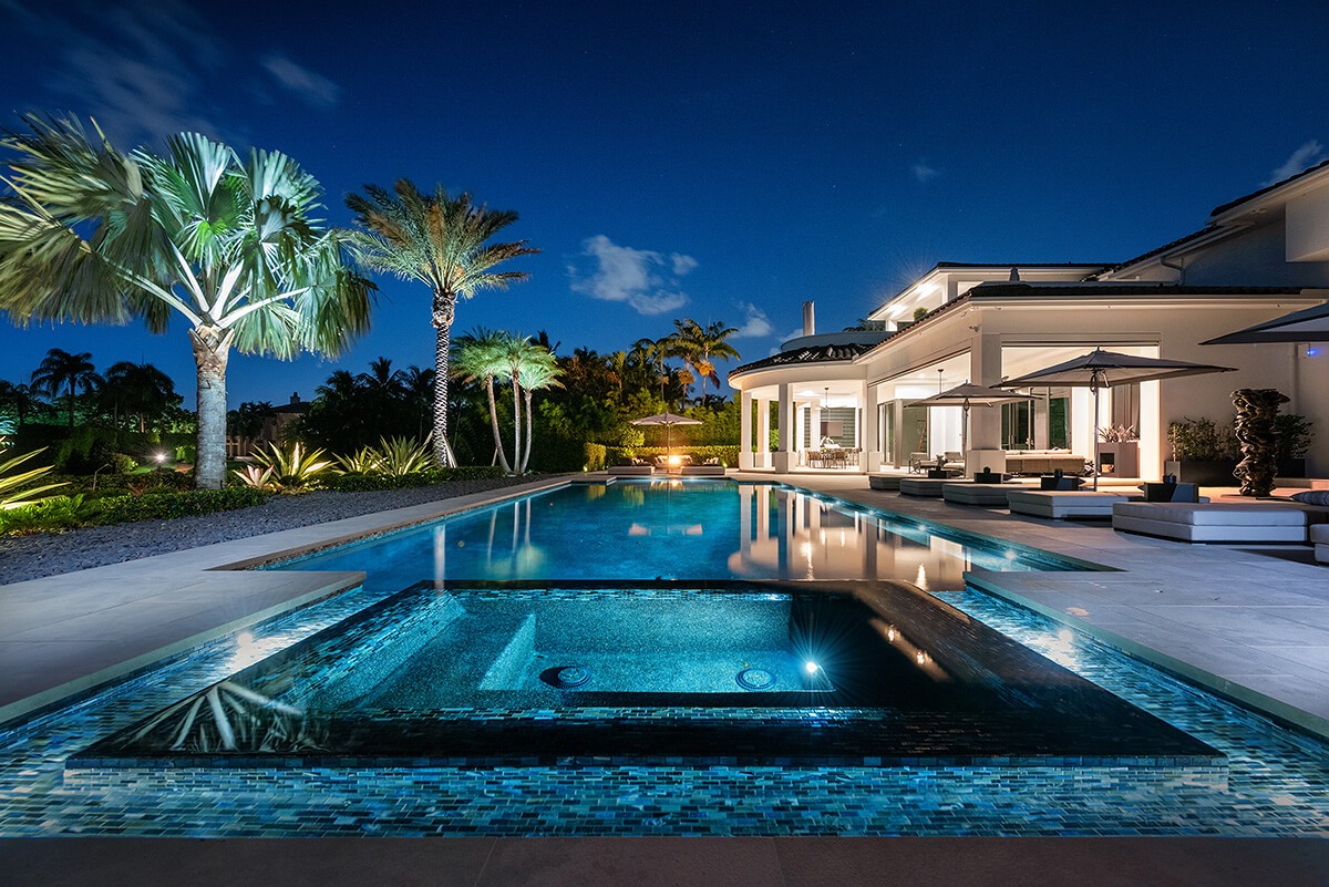 photo of a backyard pool design in PebbleTec PebbleBrilliance Tropicana Pool Finish medium blue water color with lightstreams tile features by Ike's Carter Pool Company submitted for World's Greatest Pools 2021