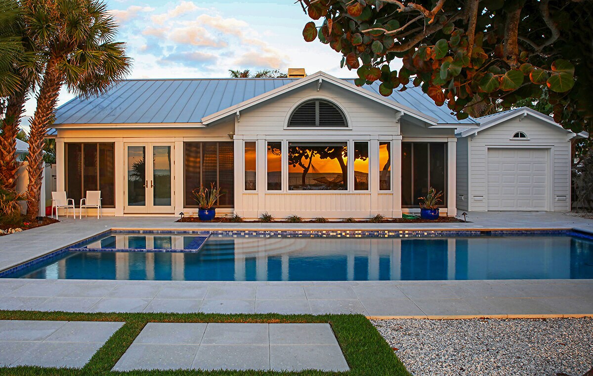 photo of a backyard pool design in PebbleTec Blue Lagoon Pool Finish medium blue water color with lightstreams tile features
