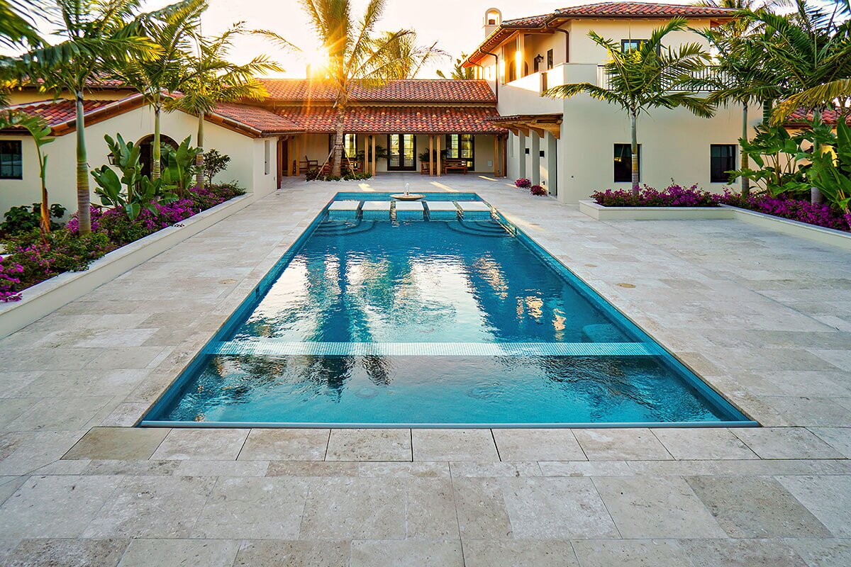 photo of a backyard pool design in PebbleTec Blue Lagoon Pool Finish medium blue water color with lightstreams tile features