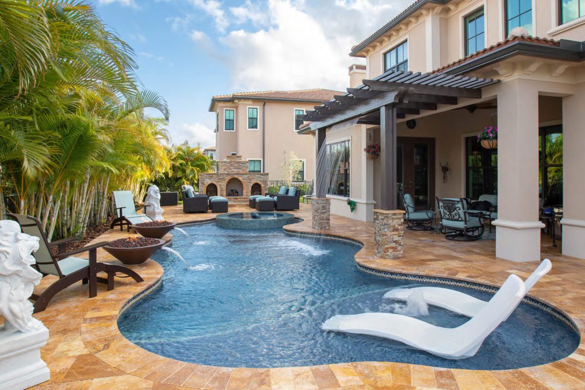 photo of a backyard pool and jacuzzi design in PebbleTec PebbleBrilliance Clearwater Pool Finish medium blue water color with a waterfall and Fire and Water bowl features submitted for World's Greatest Pools 2019