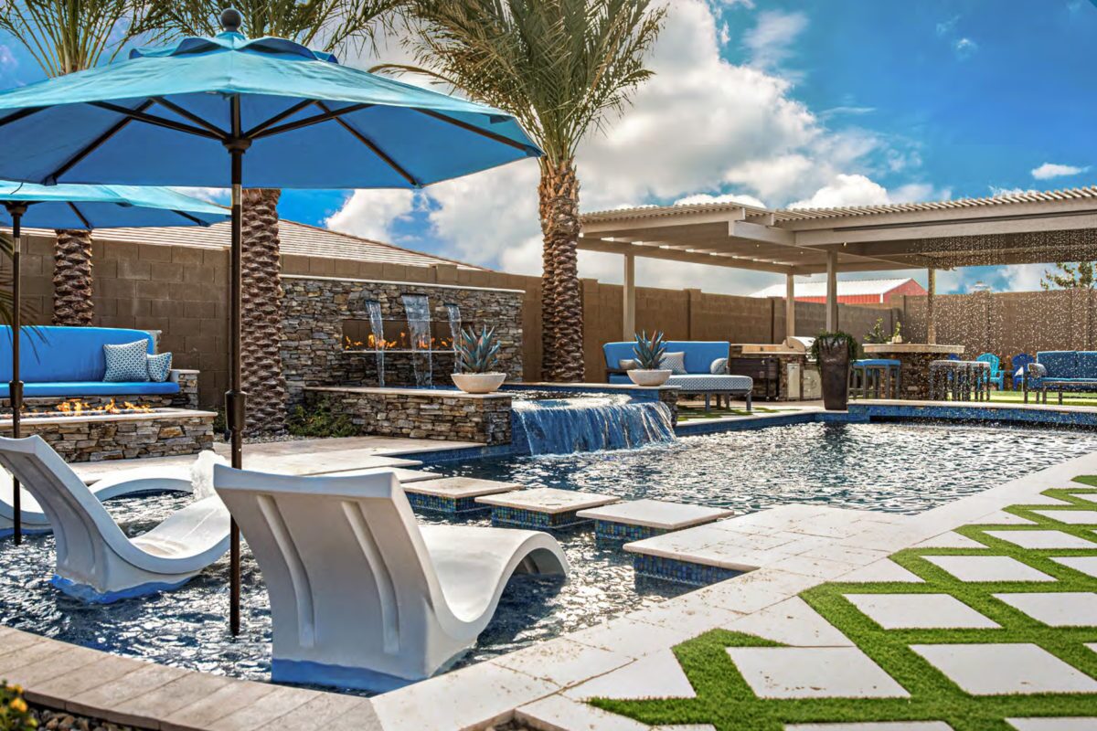 photo of a backyard pool design in PebbleTec PebbleBrilliance Clearwater Pool Finish medium blue water color with a Fire and Water feature submitted for World's Greatest Pools 2021