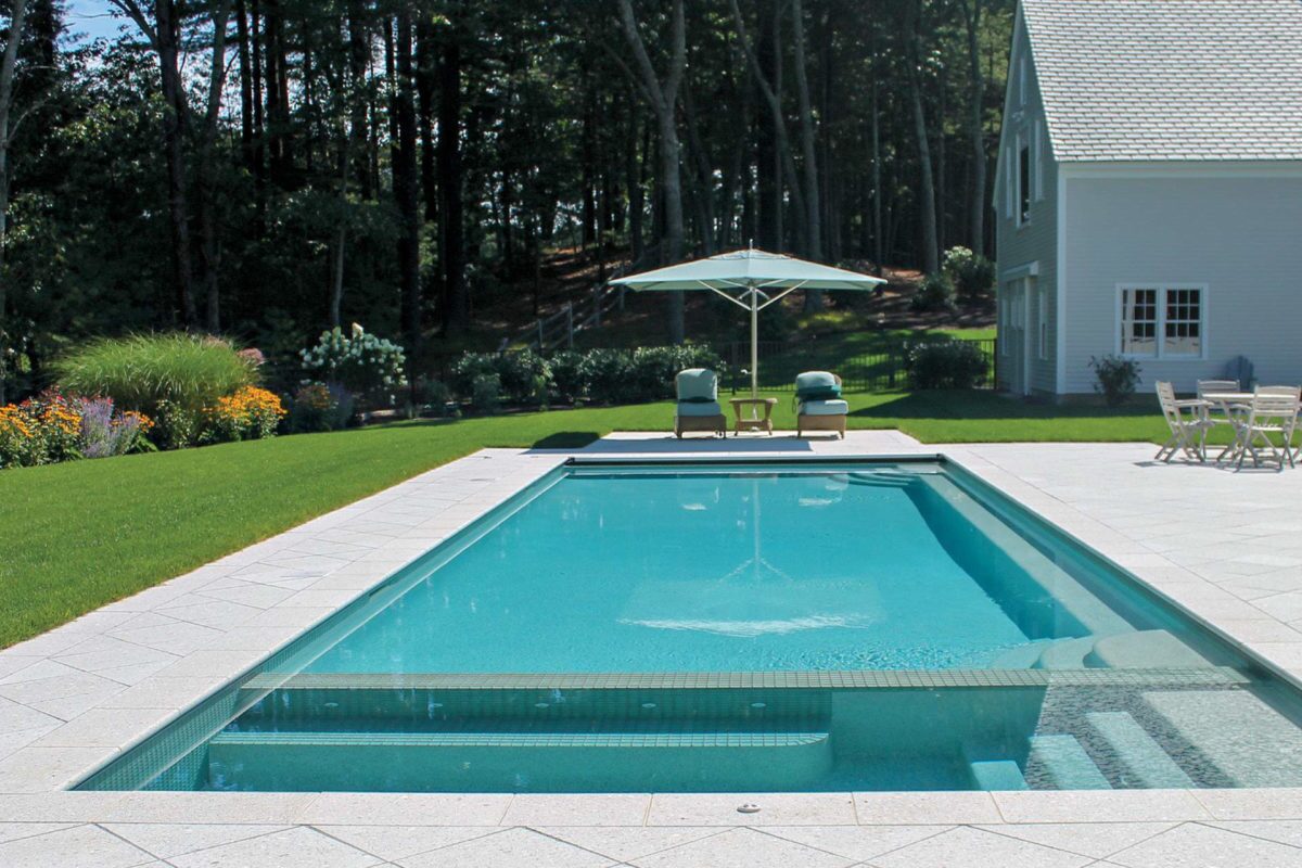 photo of a daytime backyard pool and jacuzzi in PebbleTec Sky Blue Pool Finish for World's Greatest Pools 2015 with a light blue water color