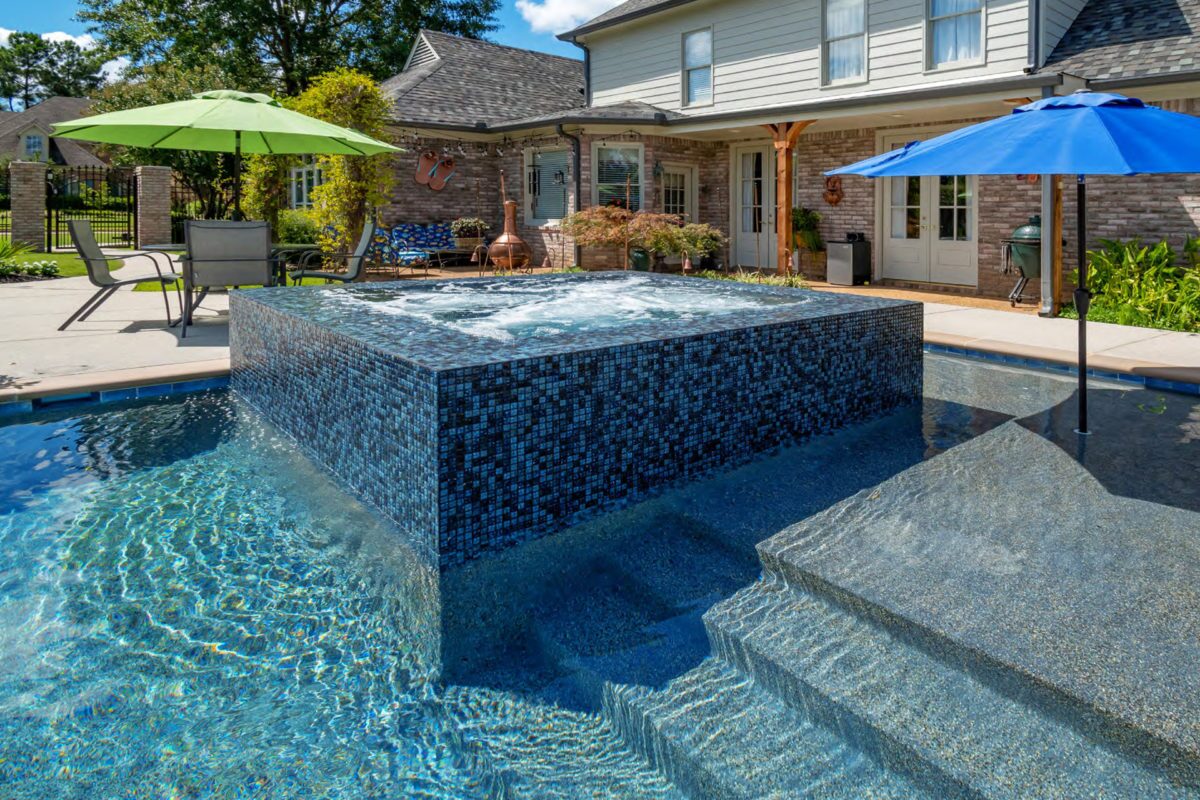 photo of a jacuzzi with lightstreams tile embellishments and pool in PebbleTec Tahoe Blue Pool Finish medium blue water color