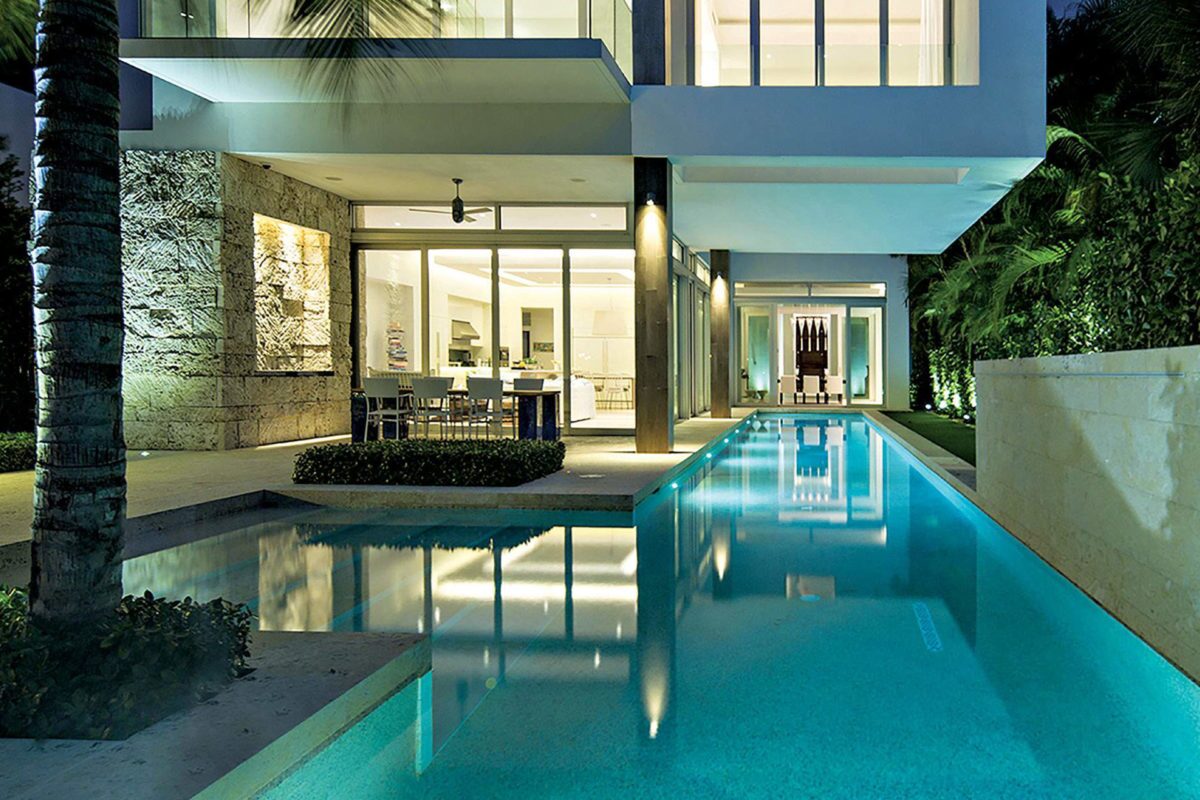 photo of a backyard lap pool in the nighttime in PebbleTec White Pearl Pool Finish for World's Greatest Pools 2015