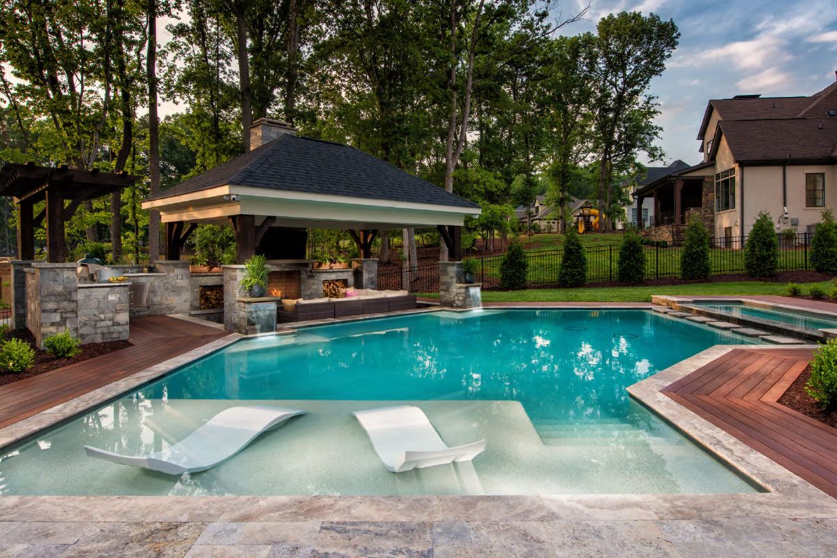 photo of a backyard pool design in PebbleTec White Pearl Pool Finish medium blue water color for World's Greatest Pools 2021