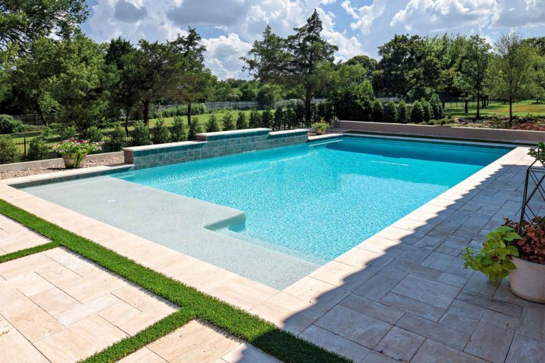 photo of PebbleBreeze Gulf Shores Water Color Pool Finish in a backyard remodel with a water feature