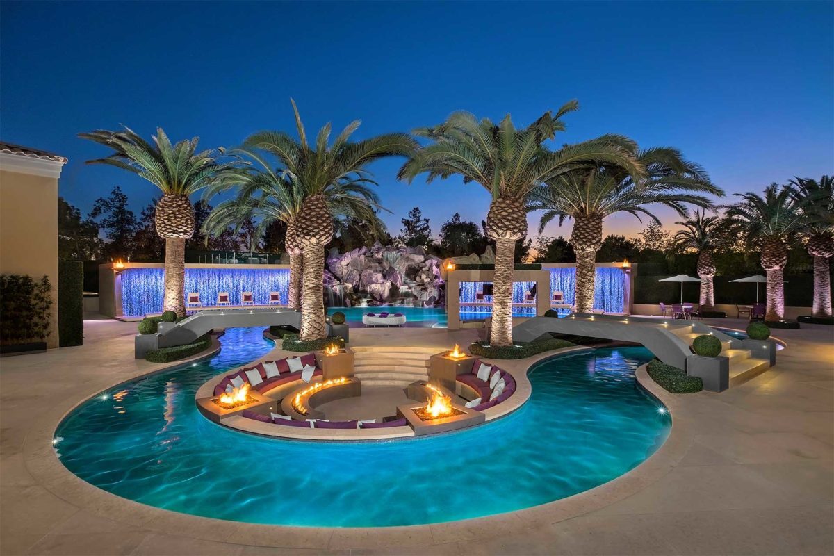 photo of backyard lazy river pool design in PebbleBreeze Silver Sea Pool Finish with fire bowls and water features by Red Rock Pools & Spas 2016 World's Greatest Pools