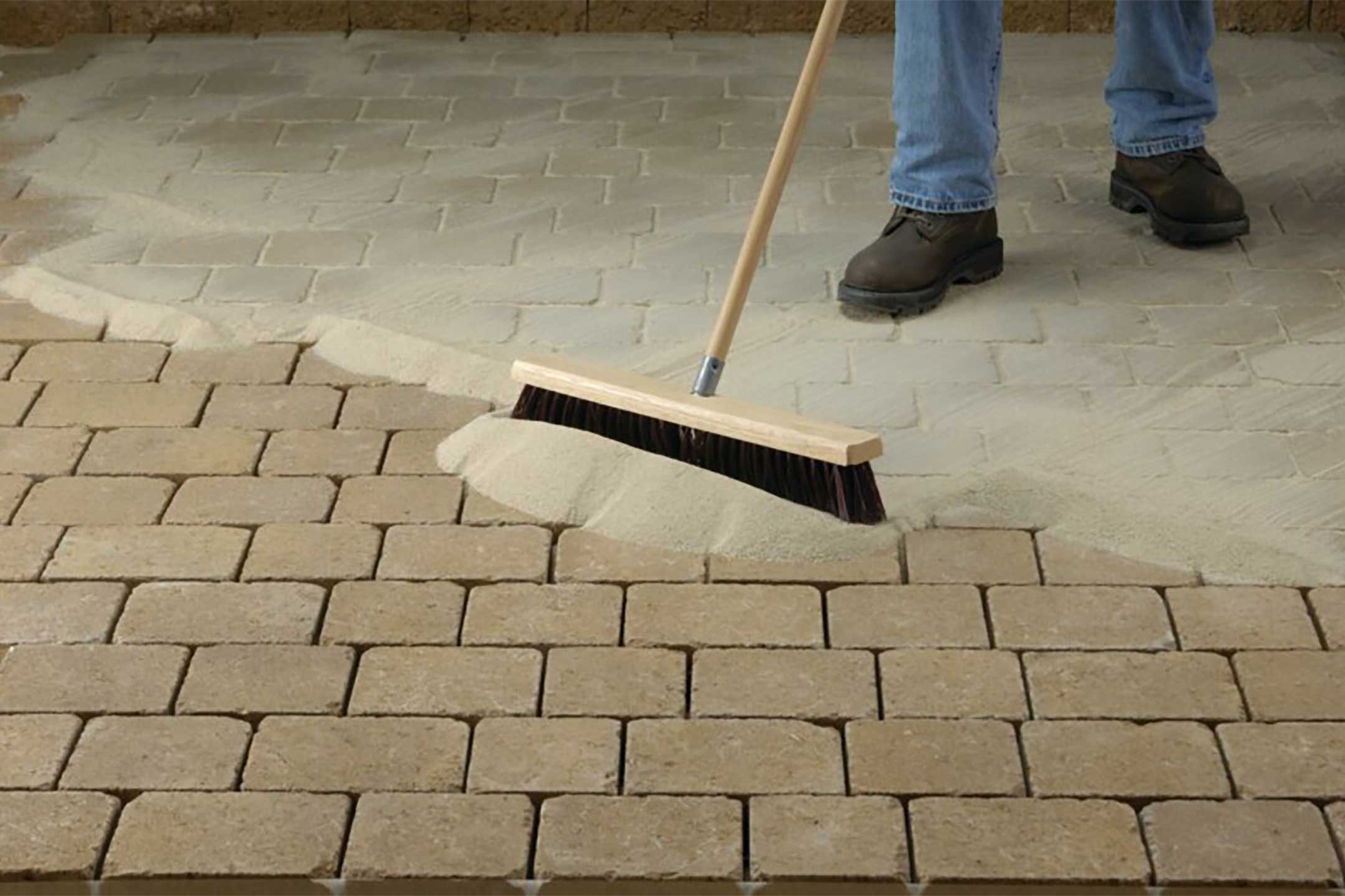 Spreading-polymeric-sand-on-concrete-pavers-techniseal-hero-image