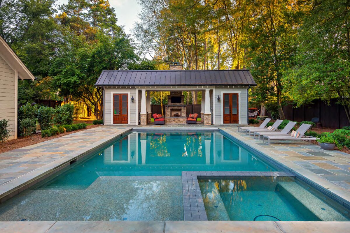 photo of a serene backyard pool and jacuzzi in PebbleTec Caribbean Blue Pool Finish from World's Greatest Pools 2021 in medium blue water color
