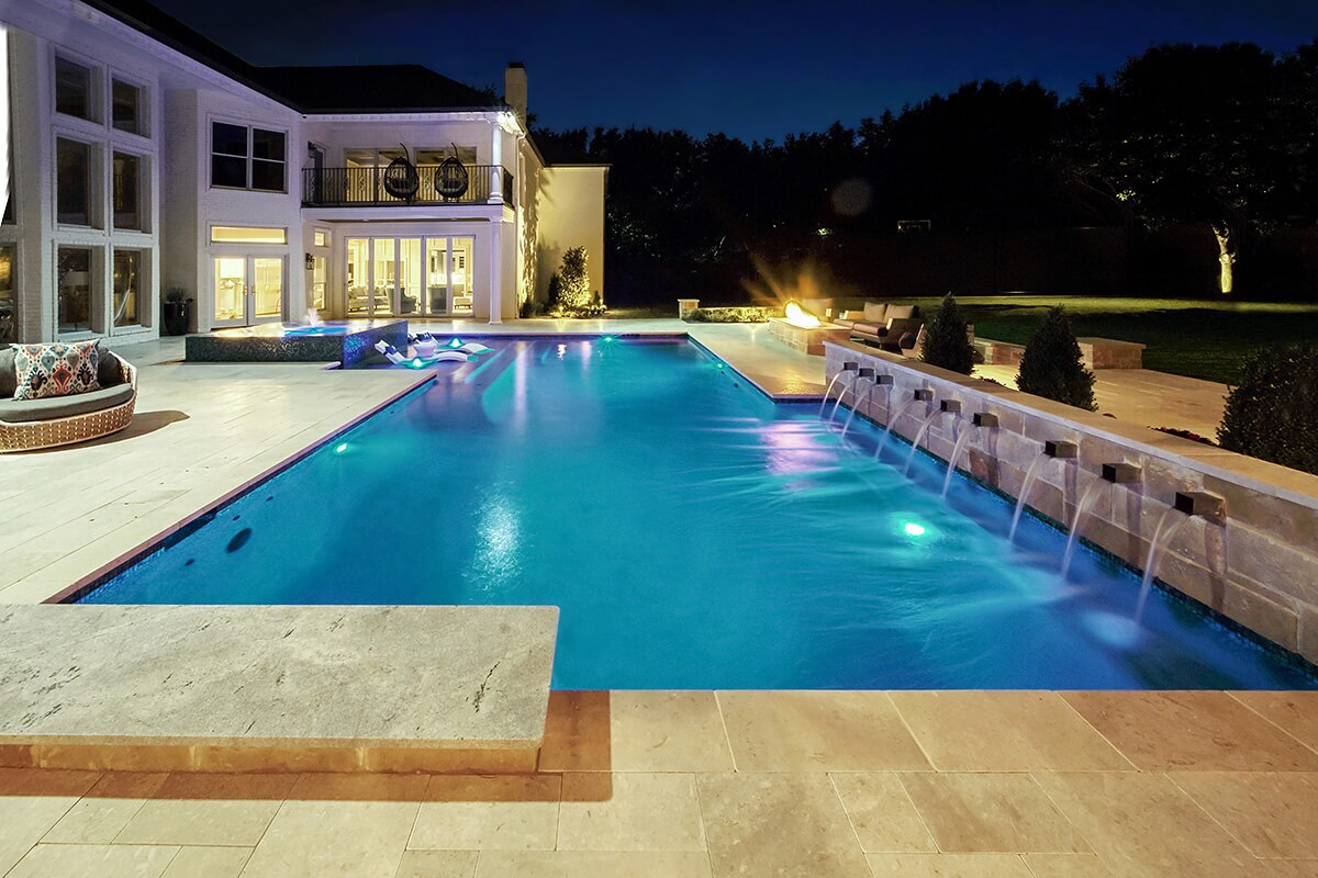 photo of a backyard pool design in PebbleTec Tropical Breeze Pool Finish medium blue water color with waterfall features
