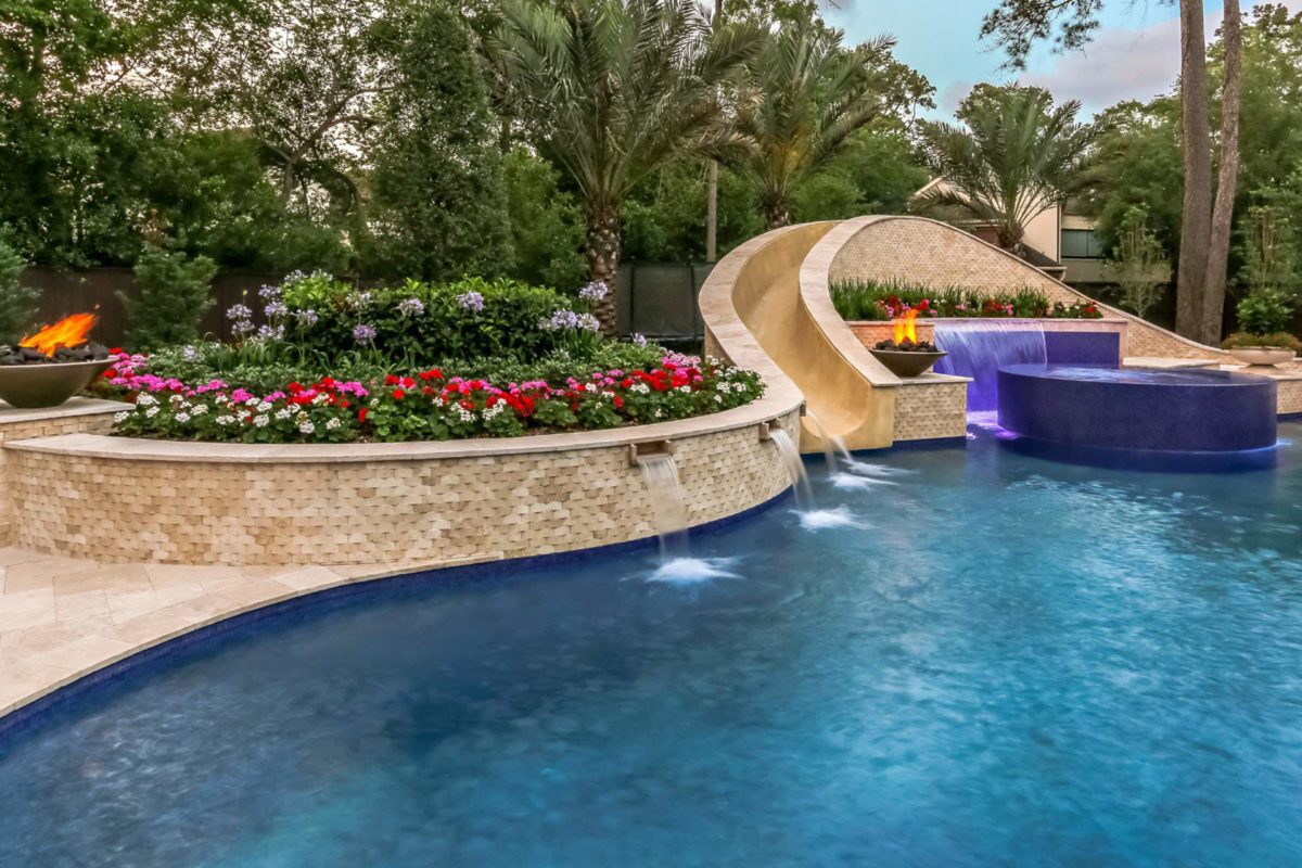 photo of a backyard pool design in PebbleTec PebbleBrilliance Deep Cove Pool Finish with a waterslide and waterfall features submitted for World's Greatest Pools 2017