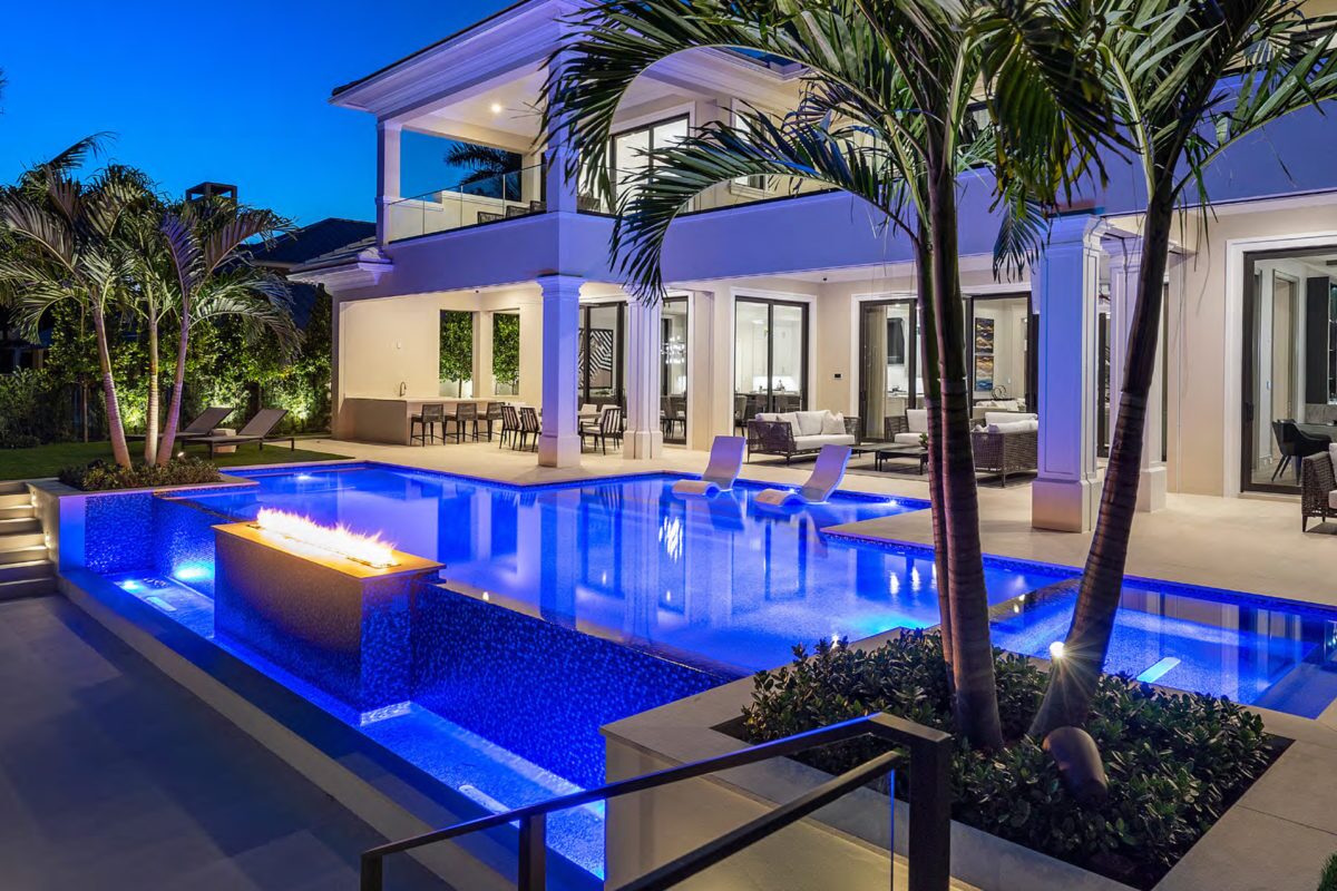 photo of a backyard pool design in PebbleTec PebbleBrilliance Deep Cove Pool Finish with a fire feature submitted for World's Greatest Pools 2021