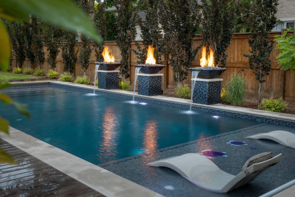 photo of a backyard pool design in PebbleTec PebbleBrilliance Majestic Sound Pool Finish medium blue water color with Fire and Water bowl features submitted for World's Greatest Pools 2019