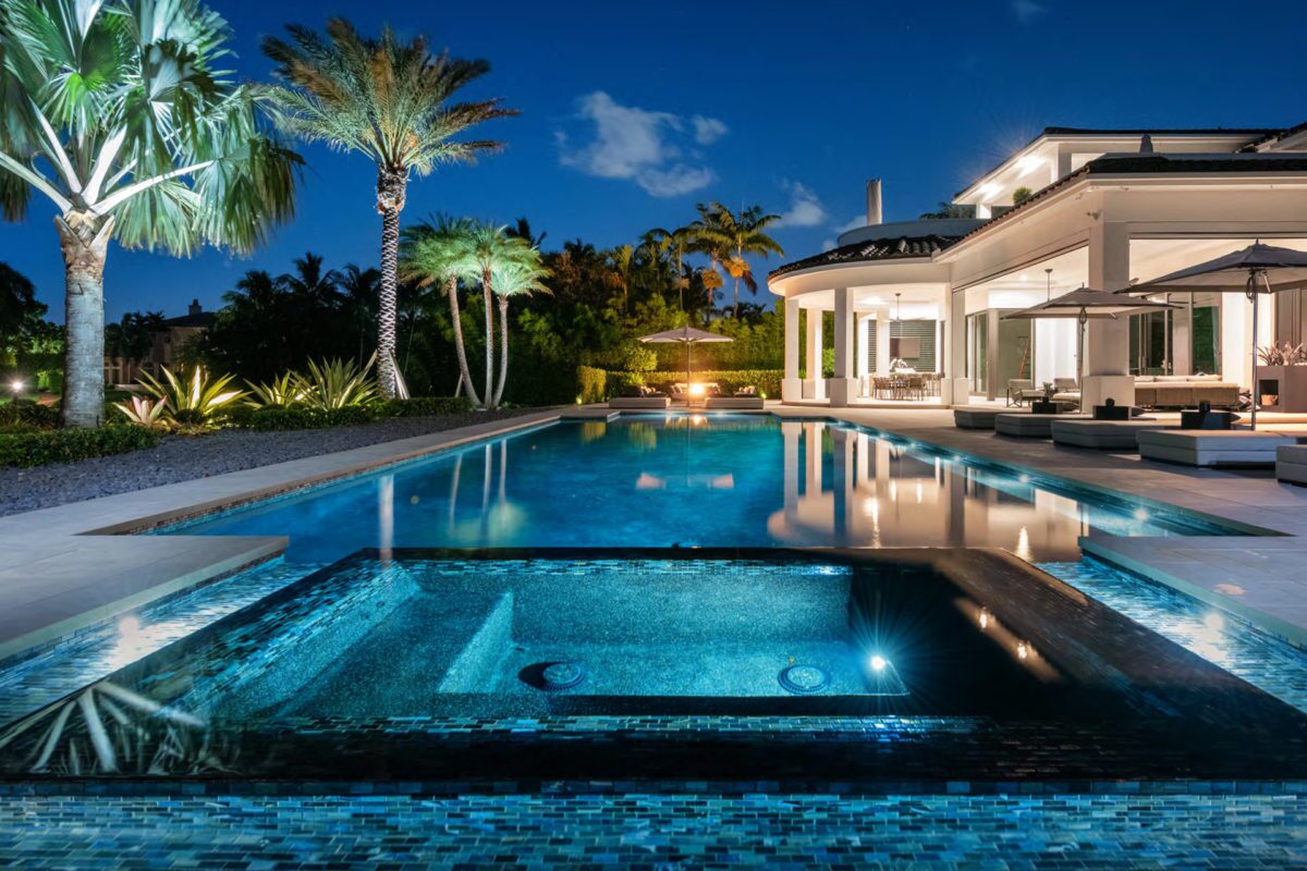 photo of a backyard pool design in PebbleTec PebbleBrilliance Tropicana Pool Finish medium blue water color in the evening submitted for World's Greatest Pools 2021
