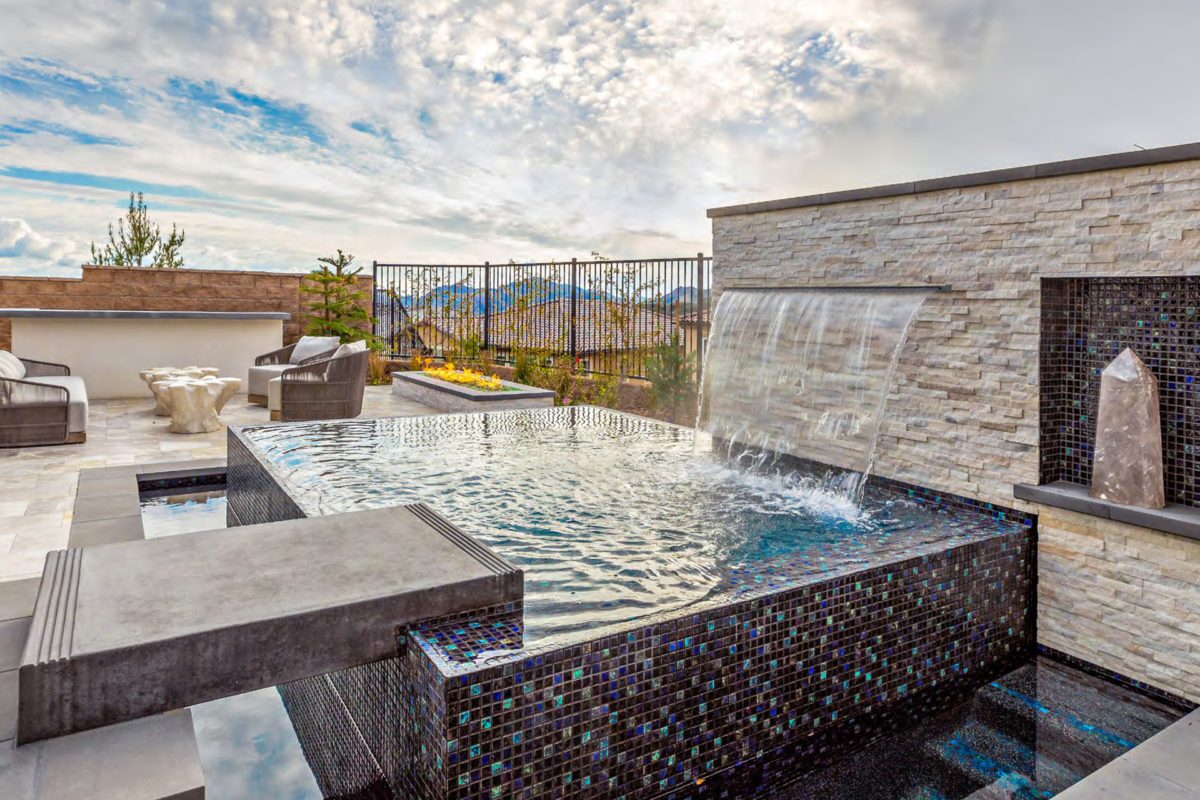 photo of a jacuzzi in PebbleTec PebbleBrilliance Tropicana Pool Finish with lightstreams tile and a waterfall feature submitted for World's Greatest Pools 2021