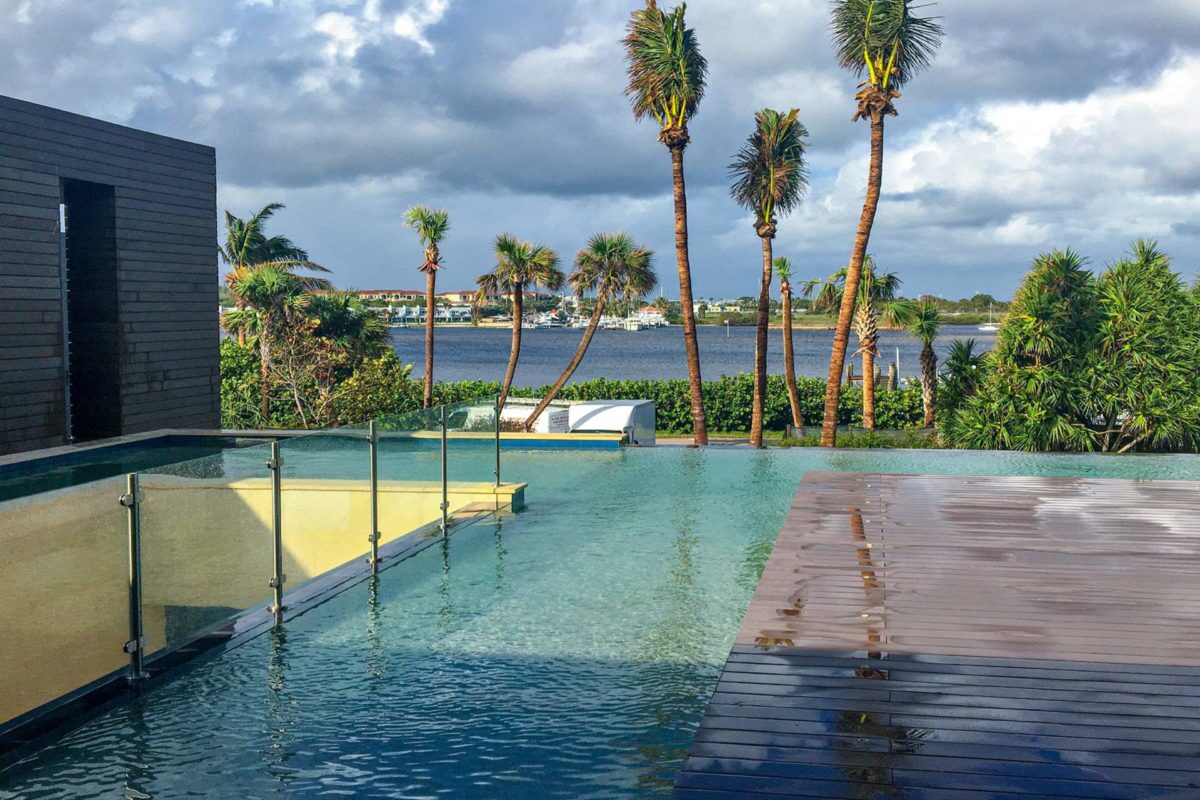photo of a backyard pool design in PebbleTec Caribbean Blue Pool Finish medium blue water color with an ocean view