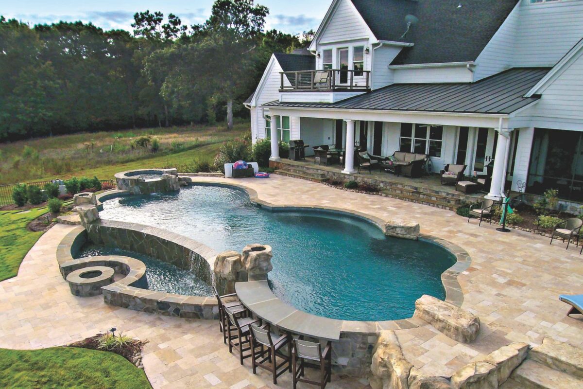 photo of a peaceful backyard pool design in PebbleTec Tropical Breeze Pool Finish medium blue water color for World's Greatest Pools 2016