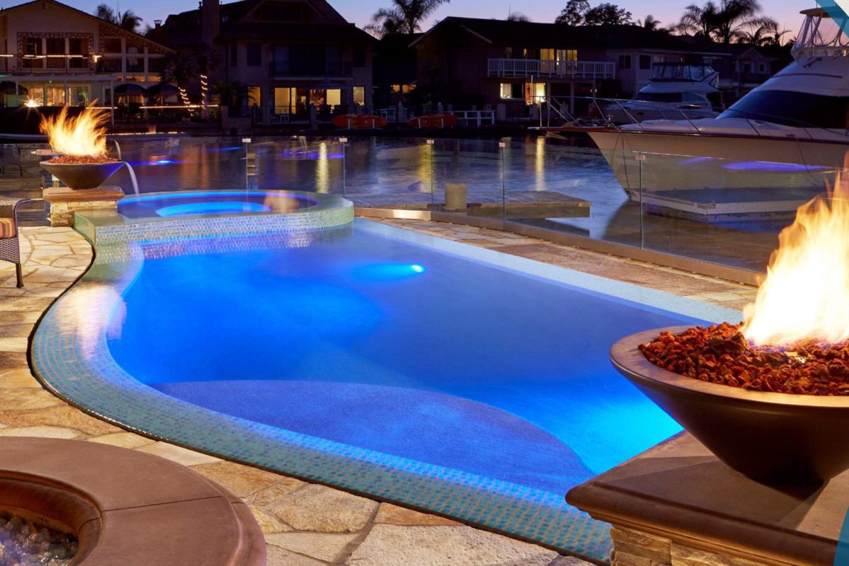 photo of a backyard pool on a river in PebbleTec Tropical Breeze Pool Finish medium blue water color with Fire and Water bowl features for World's Greatest Pools 2017