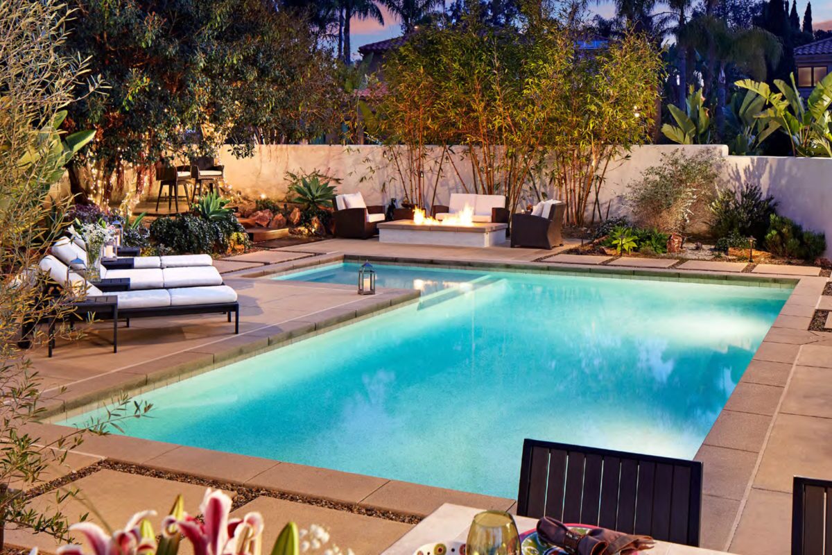 photo of a backyard design with a fire pit and pool in PebbleTec White Pearl Pool Finish light blue water color for World's Greatest Pools 2019
