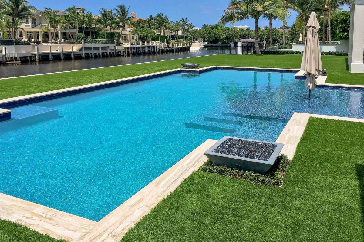 photo of a backyard pool design on the river in PebbleBreeze Fresh Water Pool Finish medium blue water color and fire bowls by Star Light Pool Builders for 2016 World's Greatest Pools