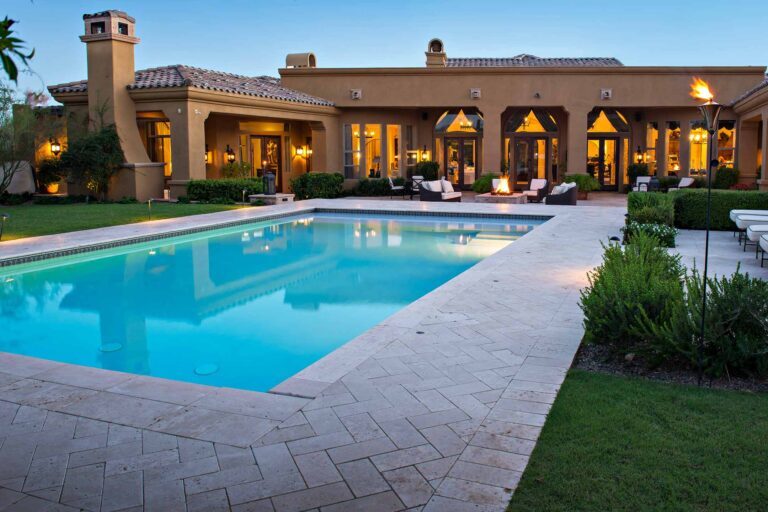photo of light blue swimming pool in modern backyard