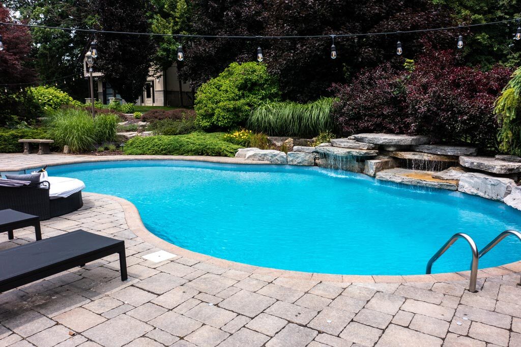Modern private pool with lounge area.